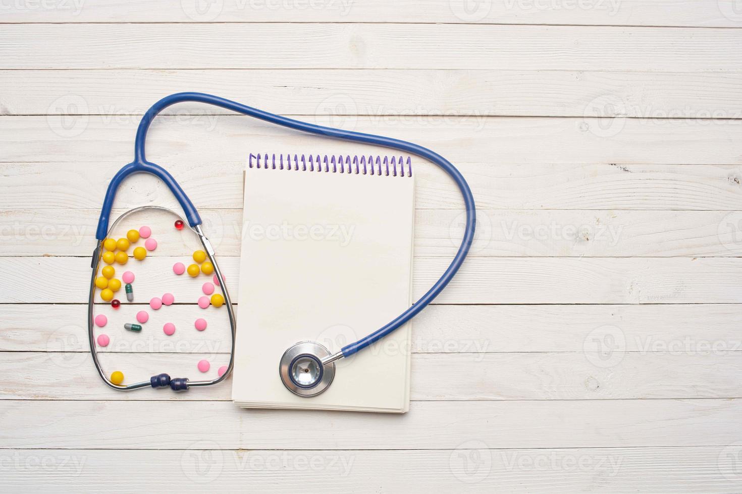 Stethoscope notepad medicine treatment top view photo