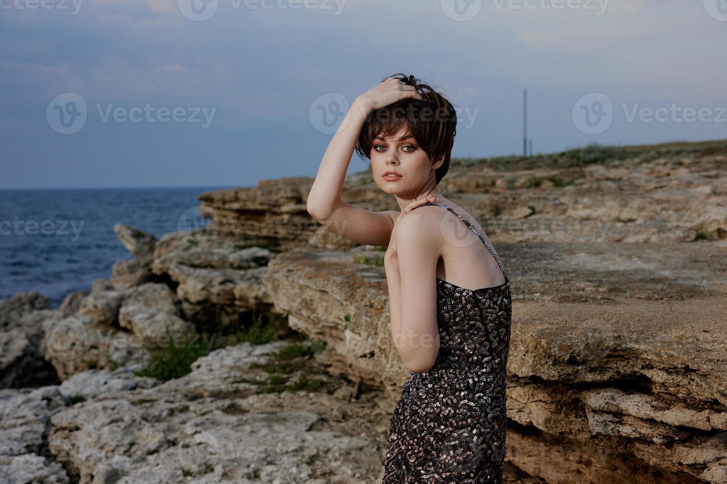 woman with makeup in dress on nature rocks landscape outdoors photo