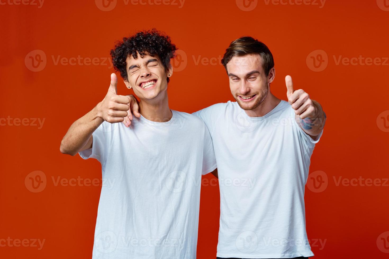 two man in white t-shirts fun emotions hand gestures friendship hugs photo