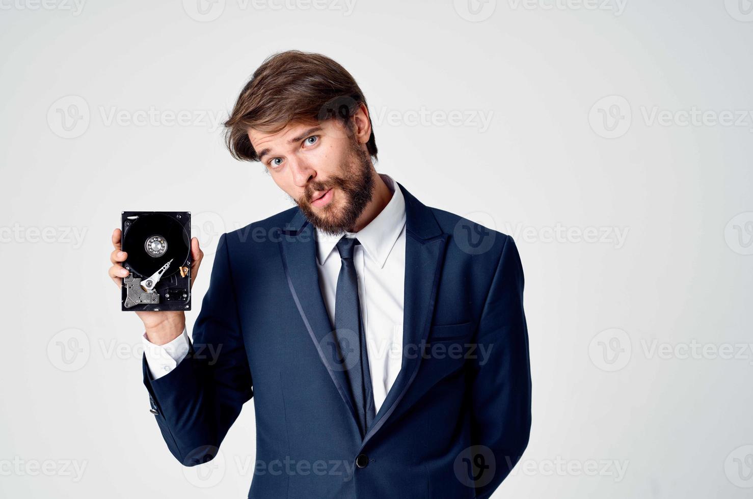 emotional business man with hard drive on computer technology photo