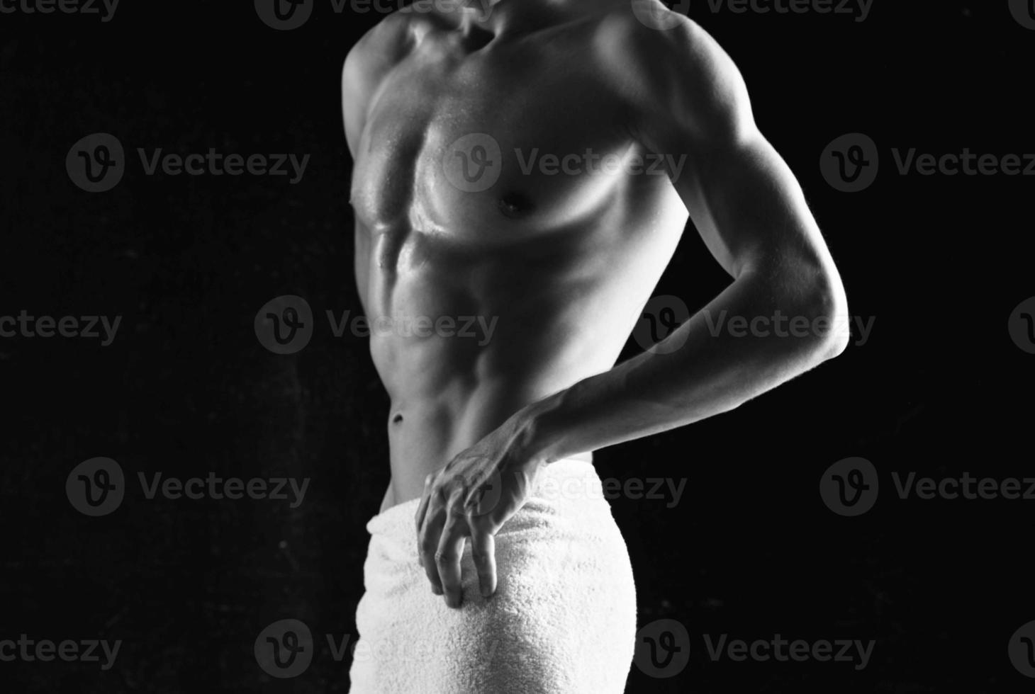 sporty man with a pumped body in white panties posing fitness photo