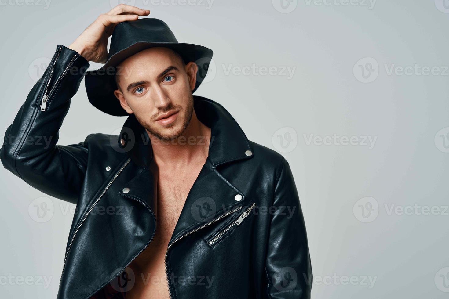 handsome man in leather jacket hat posing studio fashion photo