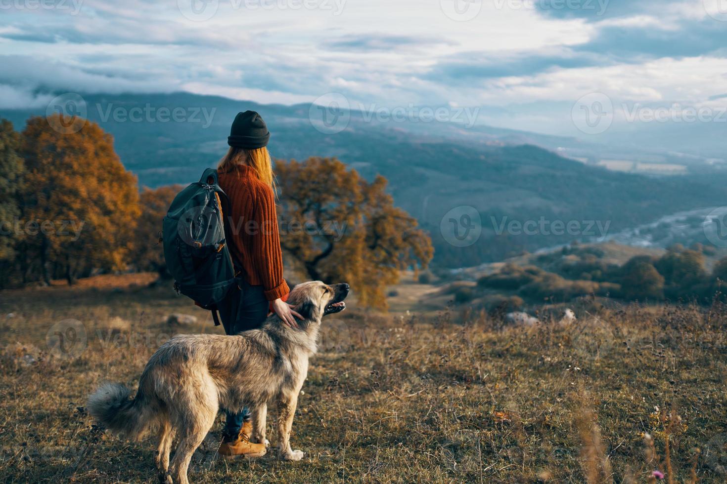 women hikers next to dog walk mountains autumn forest photo