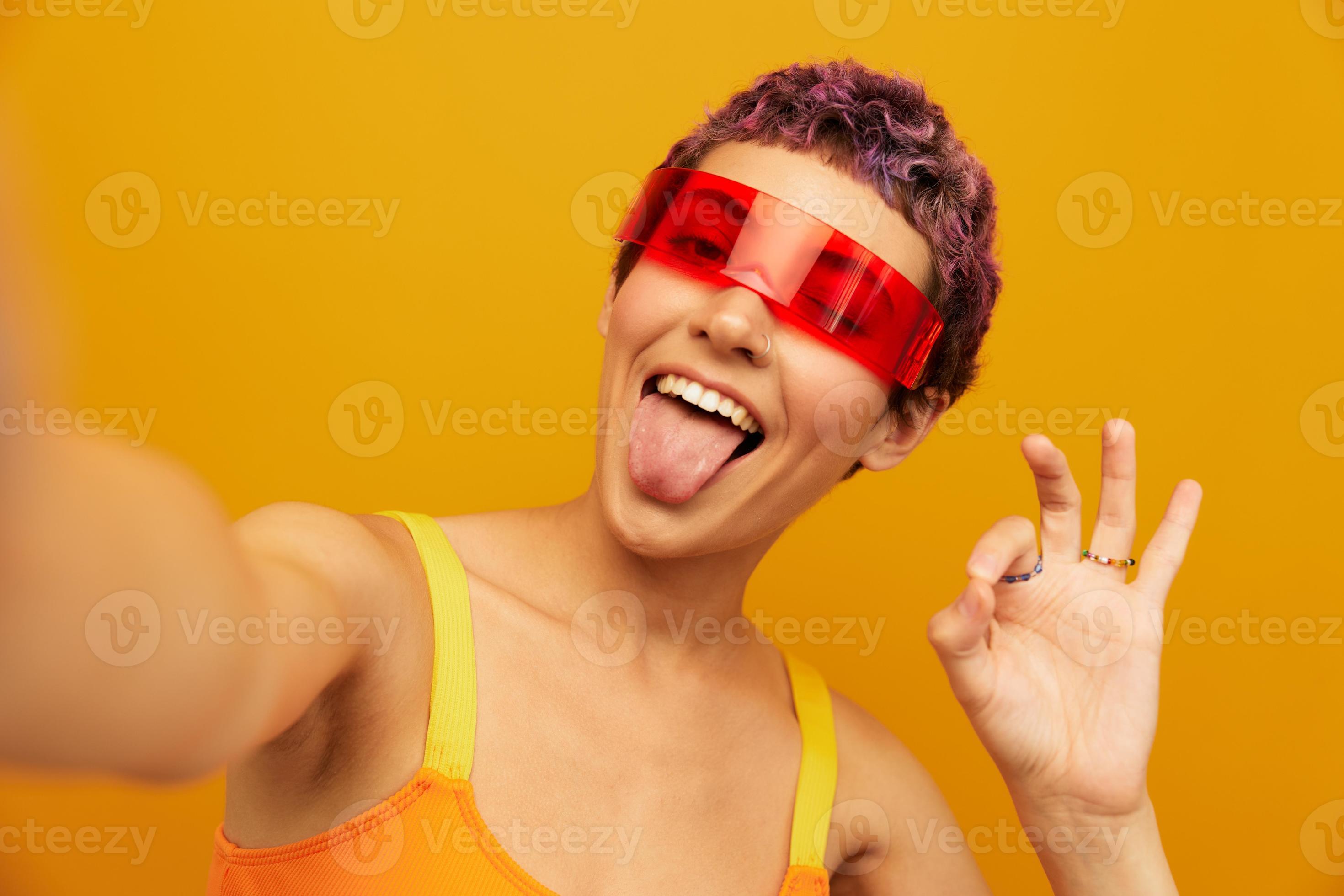 Woman wearing unusual millennial glasses taking selfies in sportswear