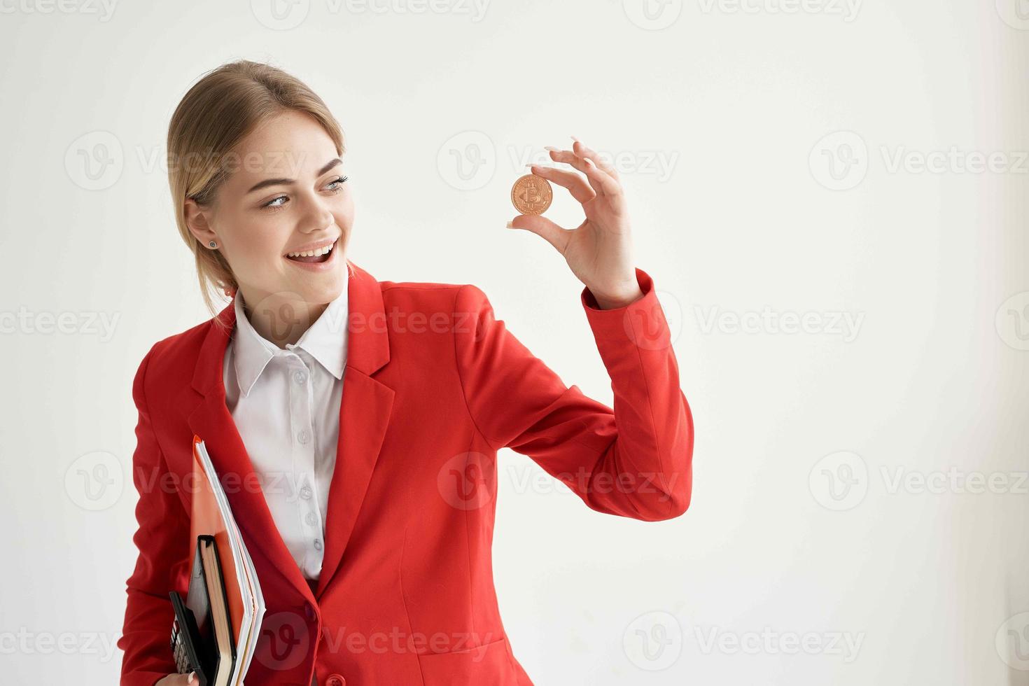 woman in a red jacket with documents in hand light background photo