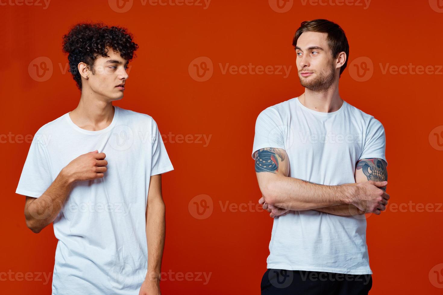 men in white t-shirts communication friendship red background photo
