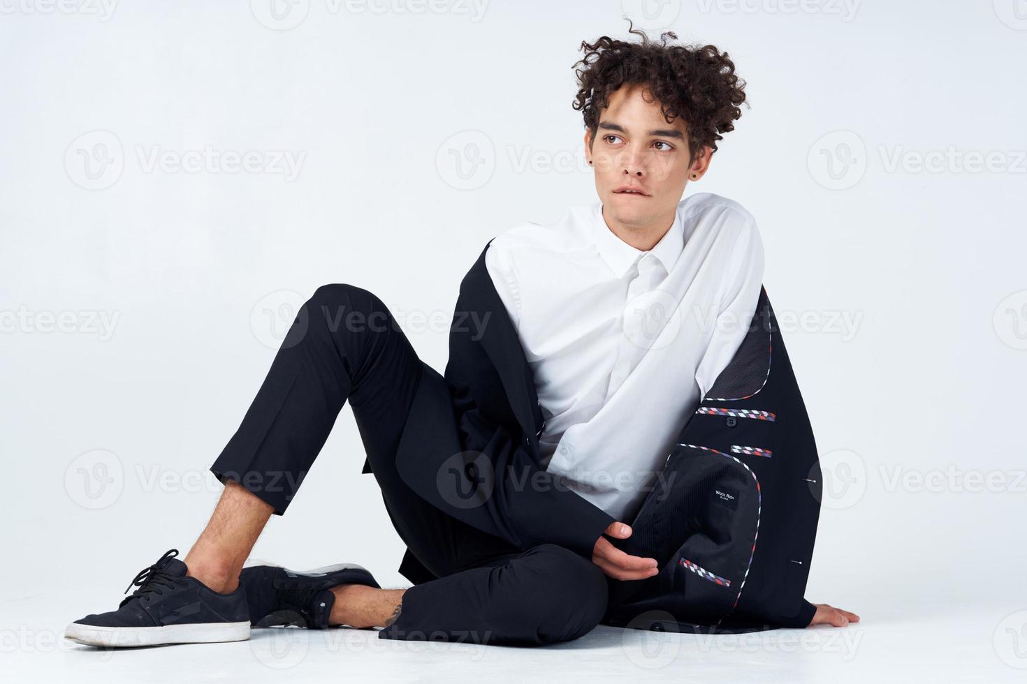 business man in a suit sitting on the floor self-confidence emotions photo