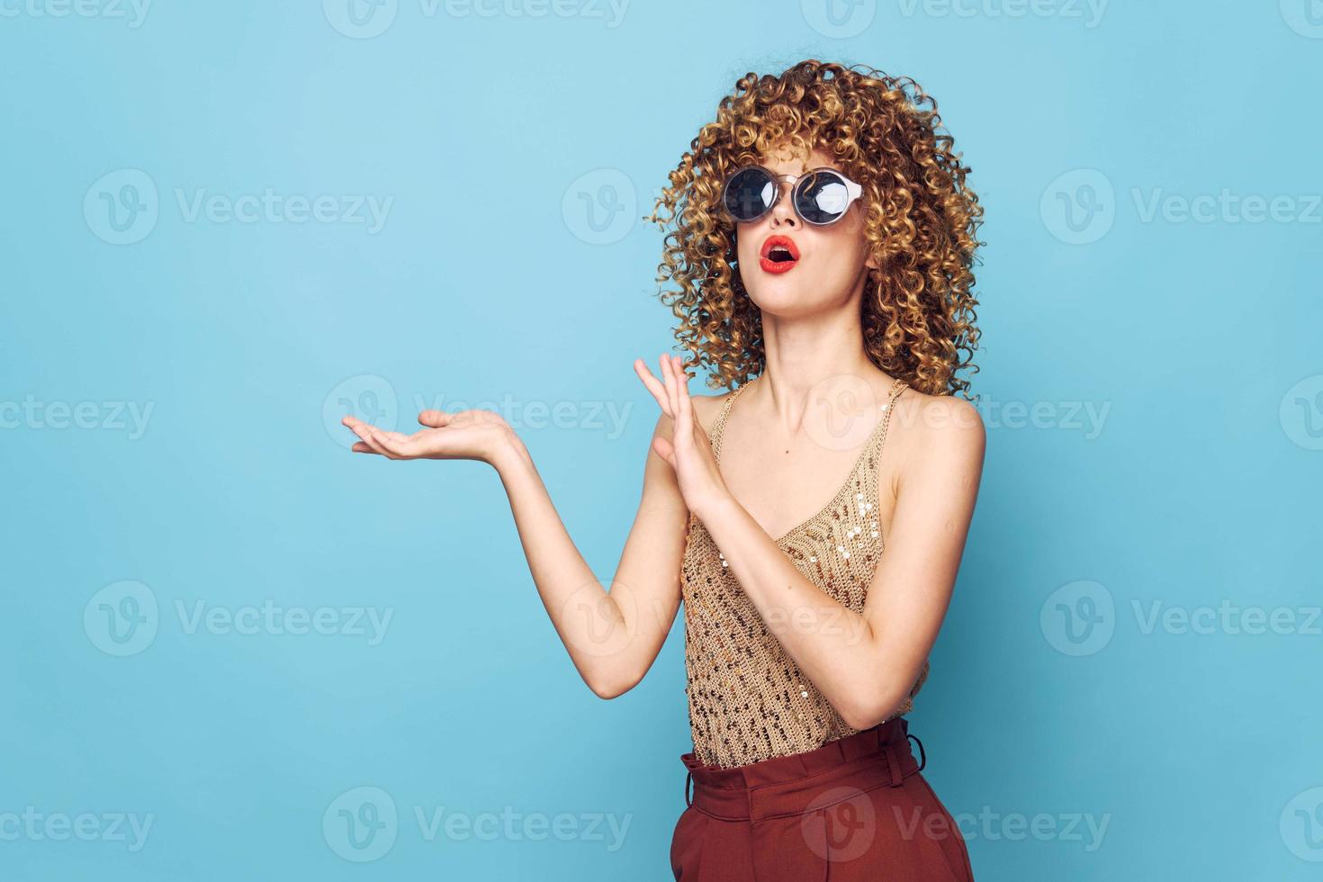 Woman portrait Curly hair red lips dark glasses hand gestures Copy Space photo