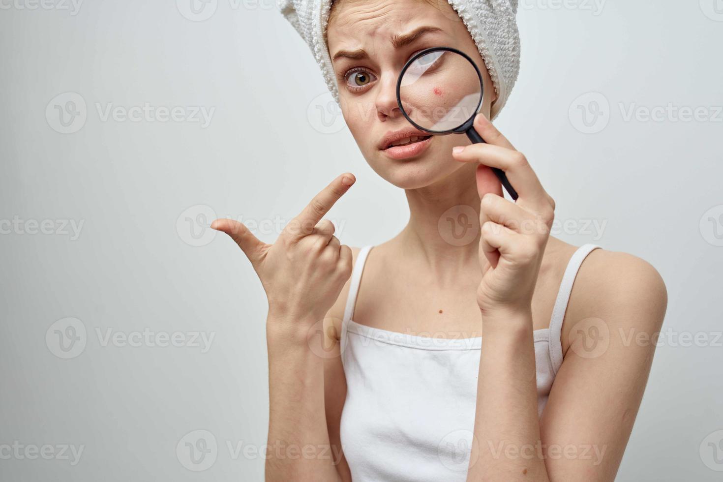 woman with a magnifying glass in hand skin problems close-up photo