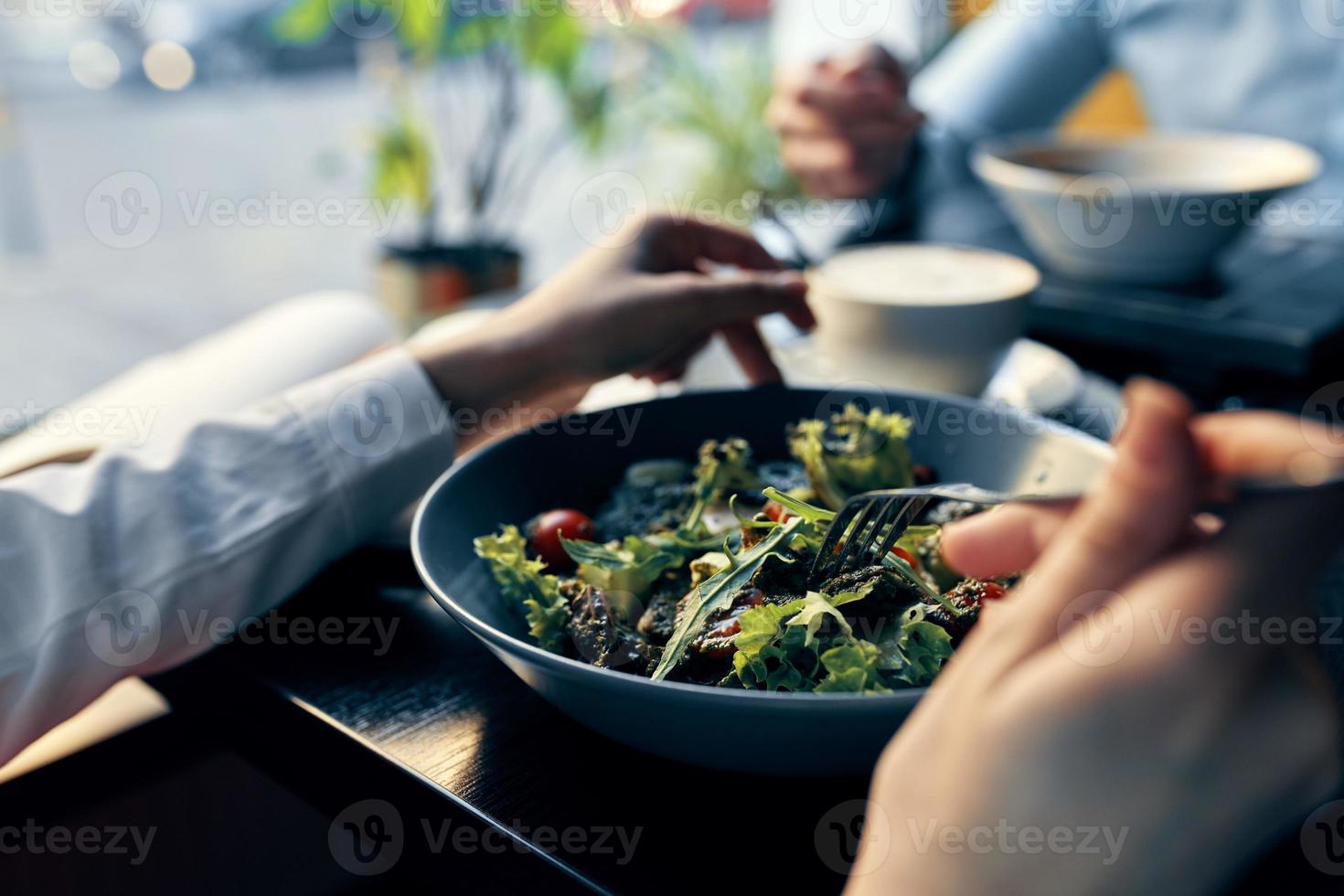 fresh salad in a plate delicious food diet fork in hand female hands cafe photo