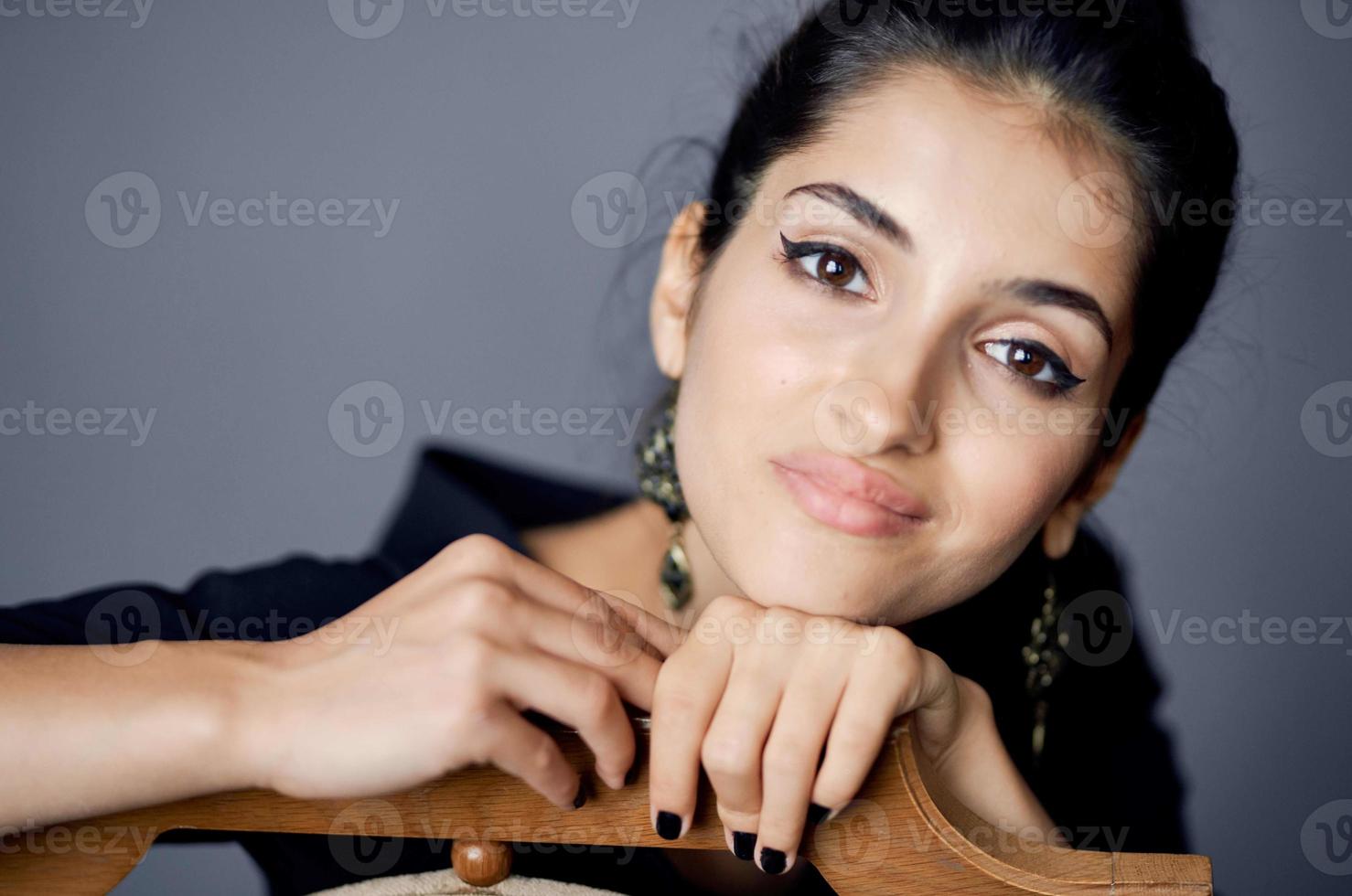 pretty woman earrings jewelry posing near the chair black dress lifestyle studio photo