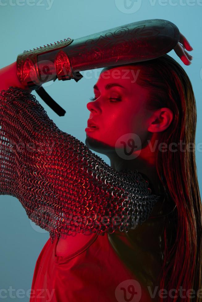 attractive woman Glamor posing red light metal armor on hand Lifestyle unaltered photo