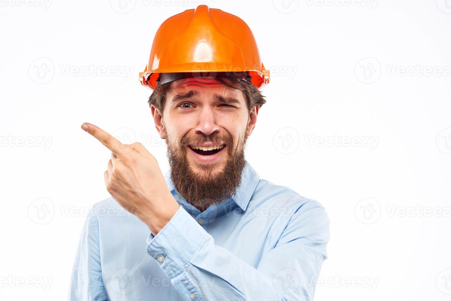 A man gestures with his hands an engineer orange hard hat safety construction photo