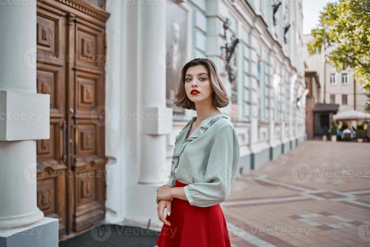 pretty woman outdoors in city near buildings lifestyle photo