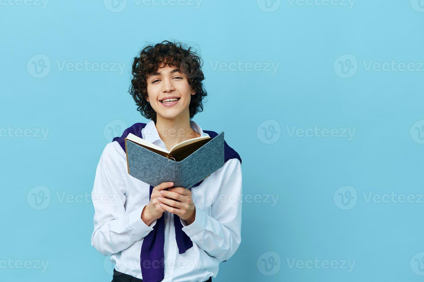 guy with a book college learning jacket blue background photo