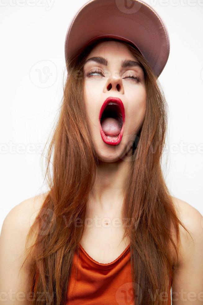 Beautiful woman in a cap Open mouth closed eyes luxury model photo