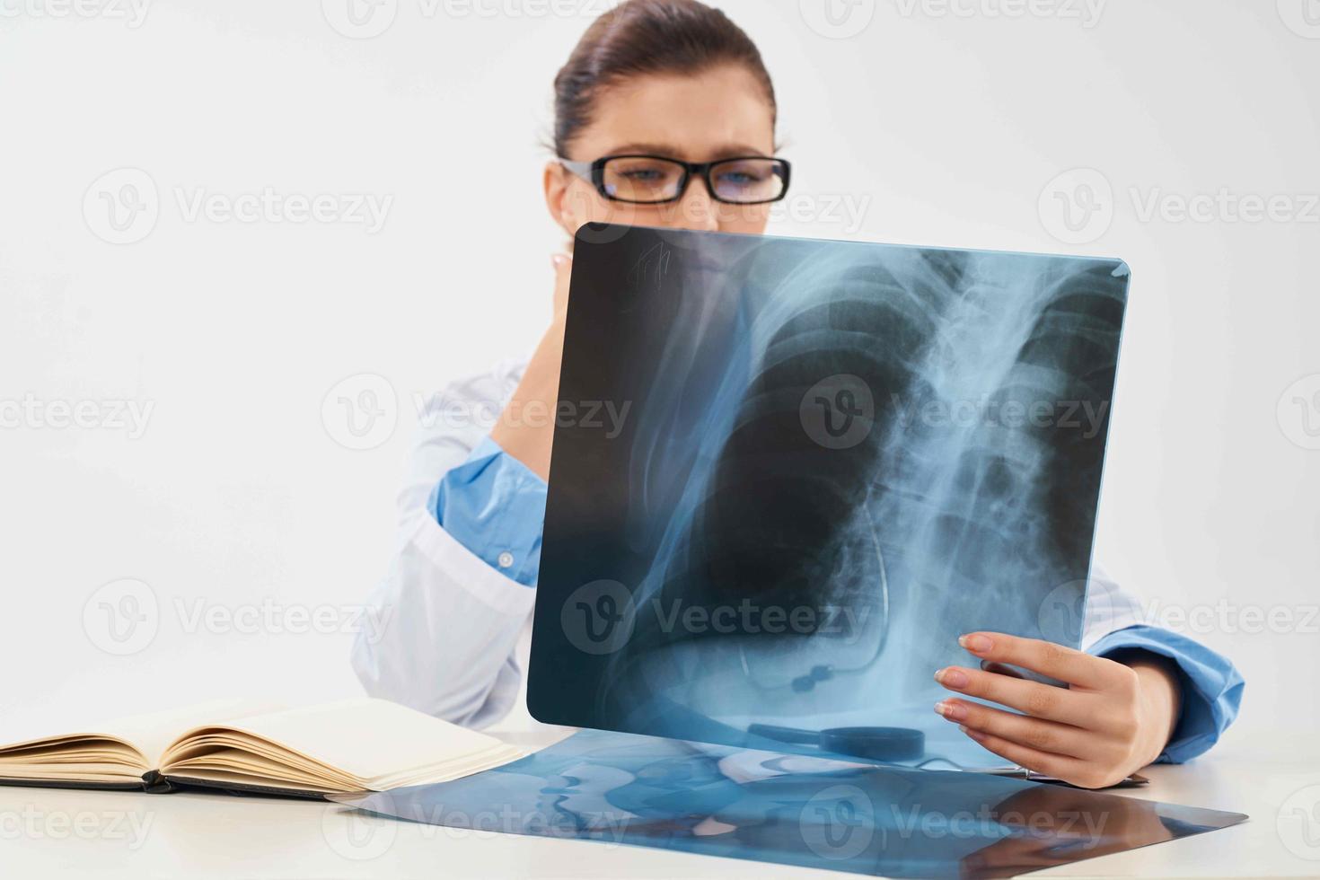 woman sitting at table x-ray and medicine hospital research photo