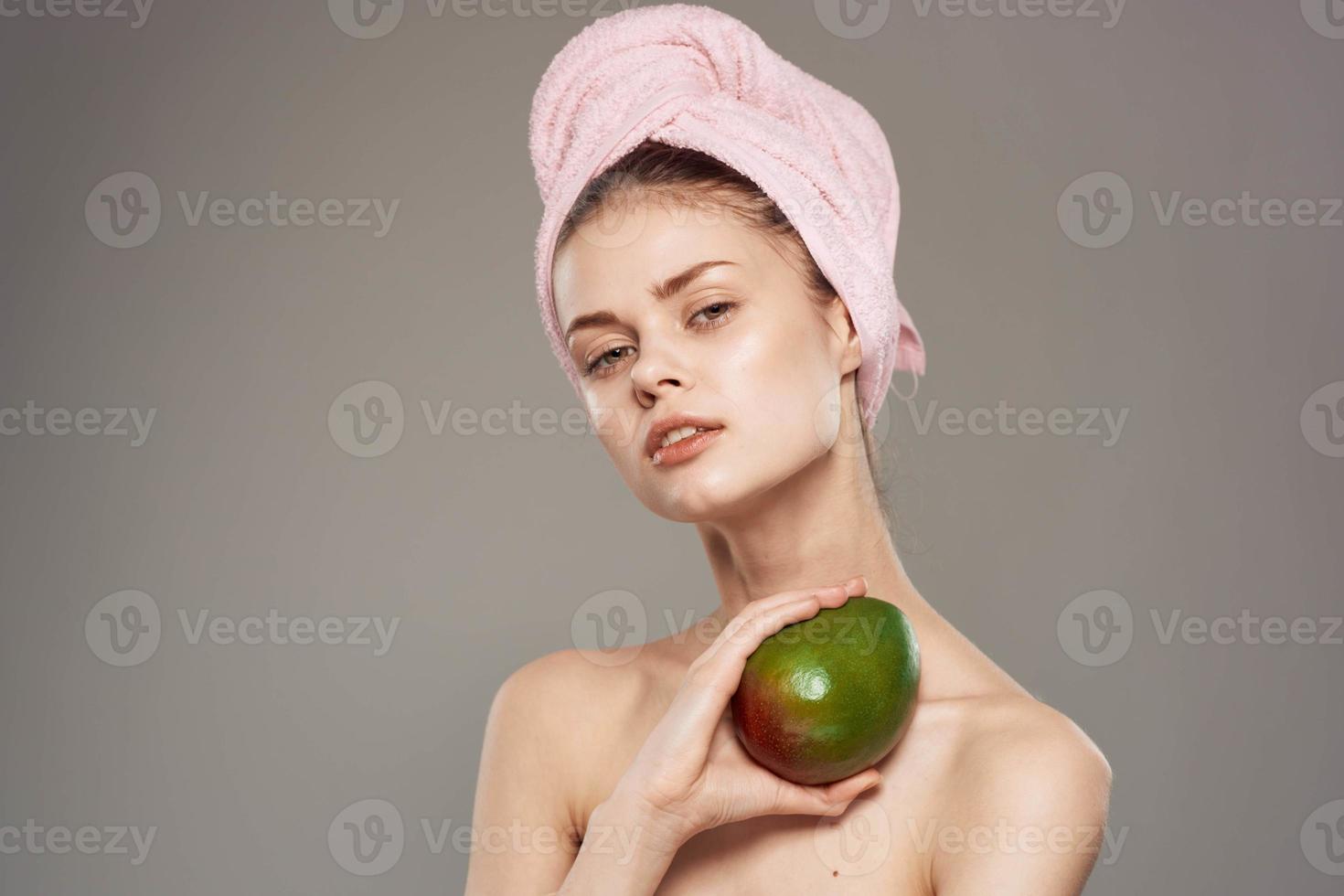 pretty woman with pink towel on head mango bare shoulders vitamins photo