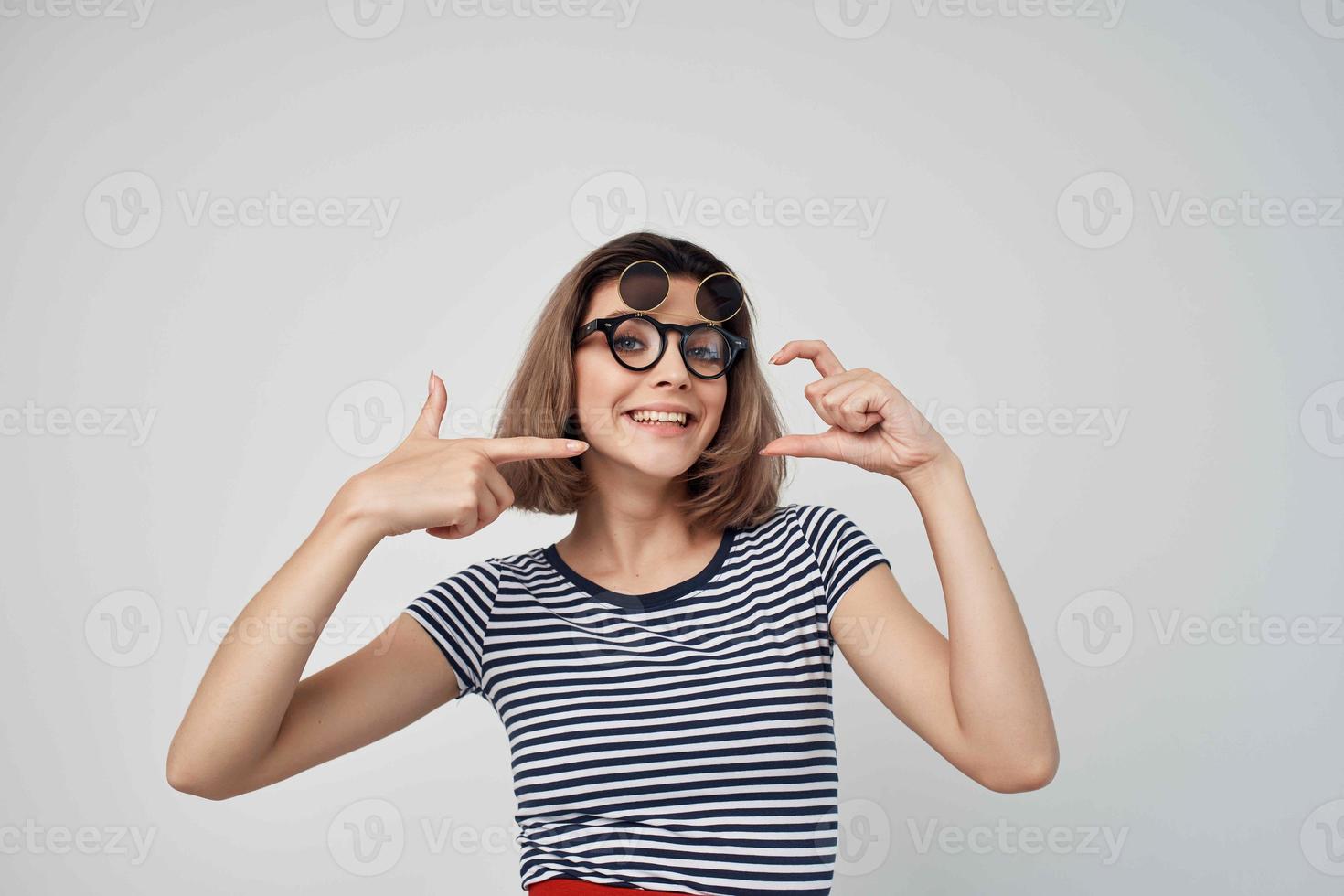 cheerful fashionable woman in striped t-shirt glasses posing summer photo