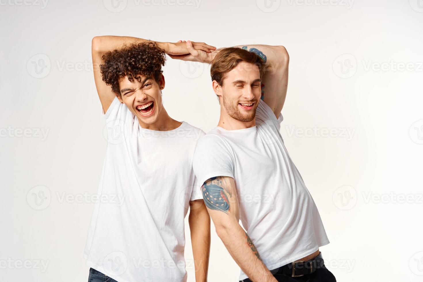 two funny friends in white t-shirts laughing positive emotions photo