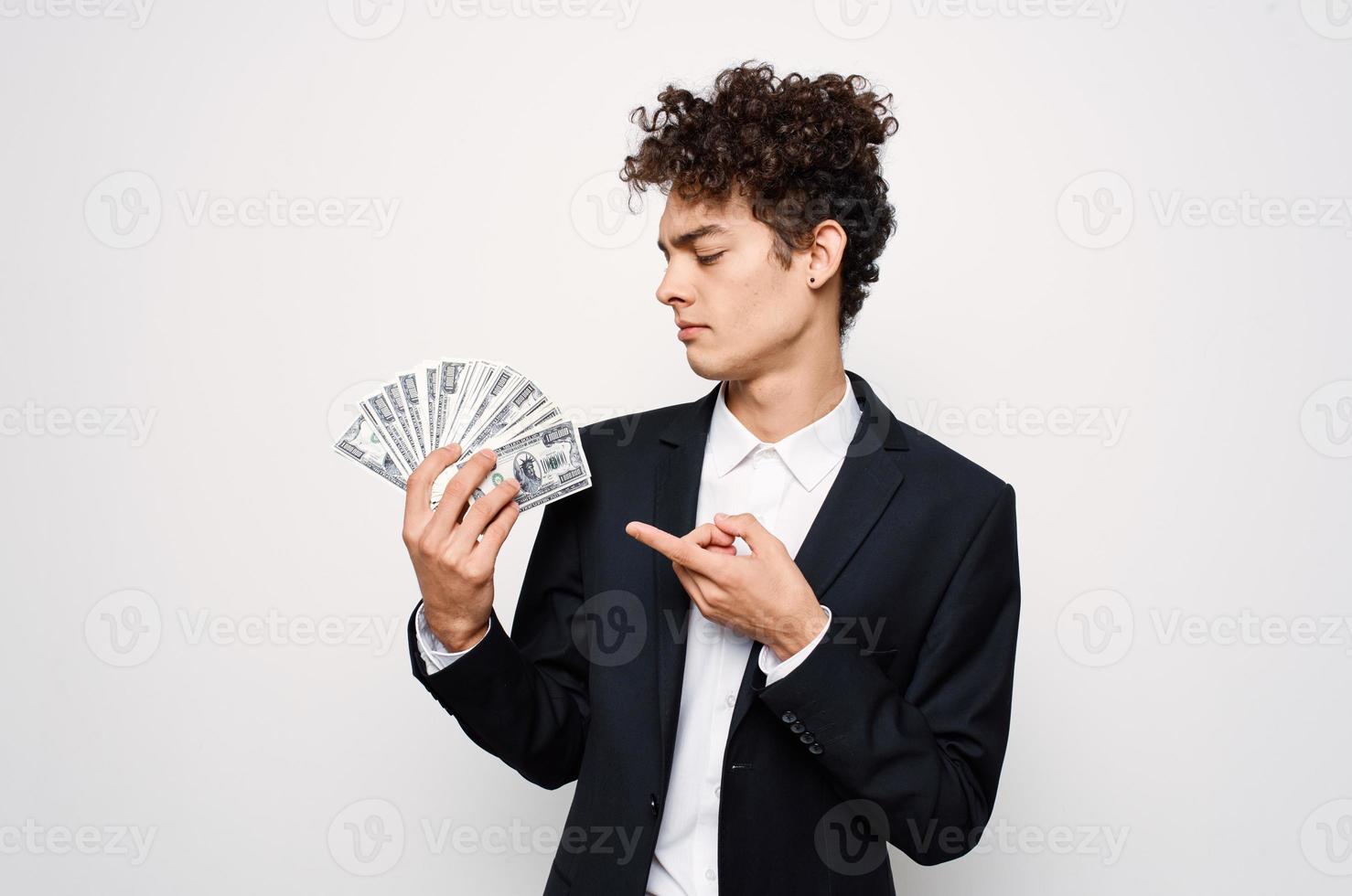 Cheerful guy with curly hair in suit official isolated background photo