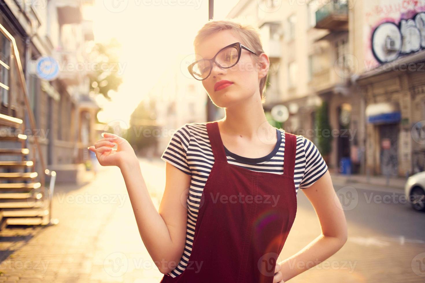 pretty woman with short hair outdoors walking in the city photo