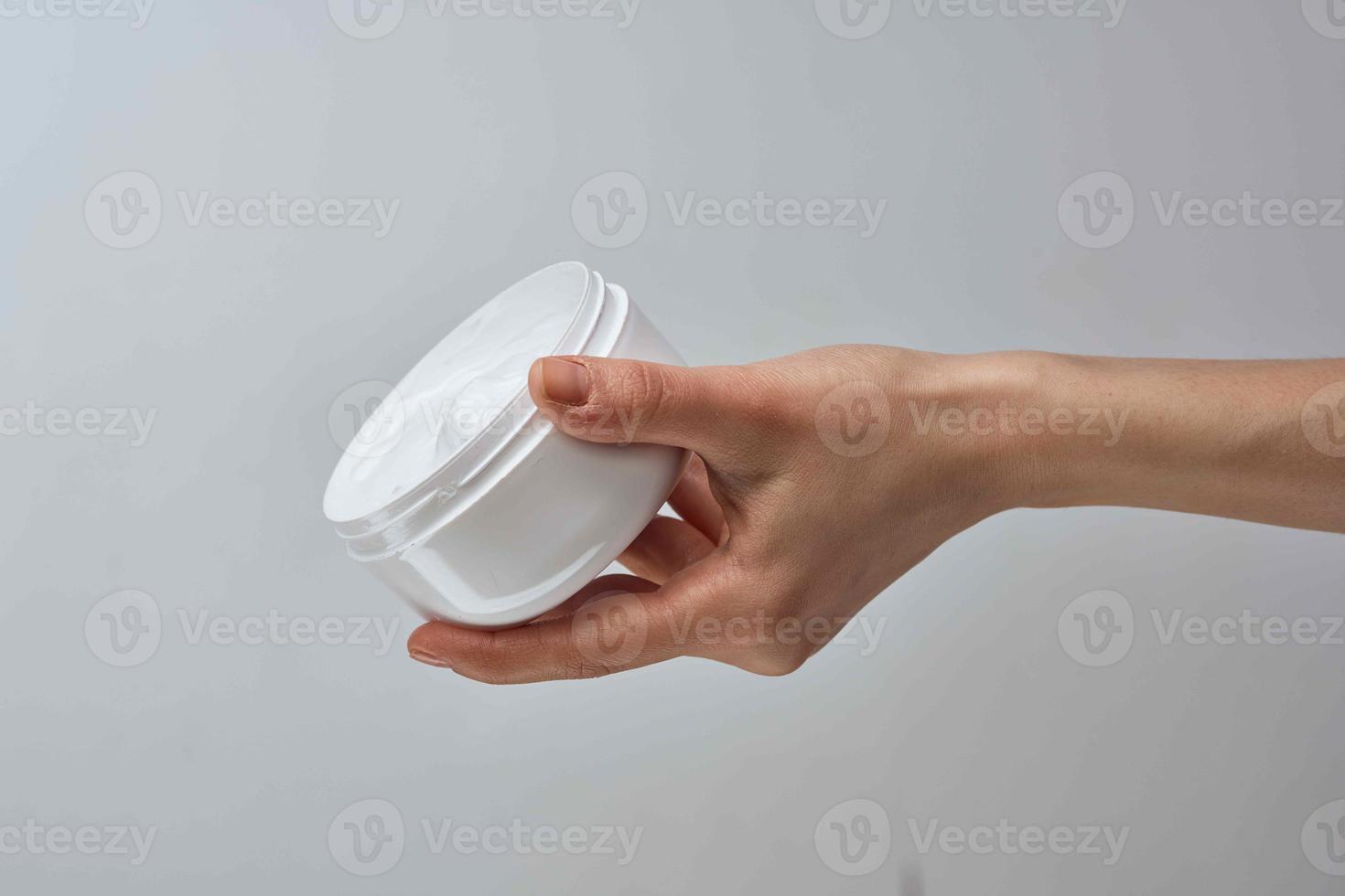 cream in female hands moisturizing dermatology skin care photo