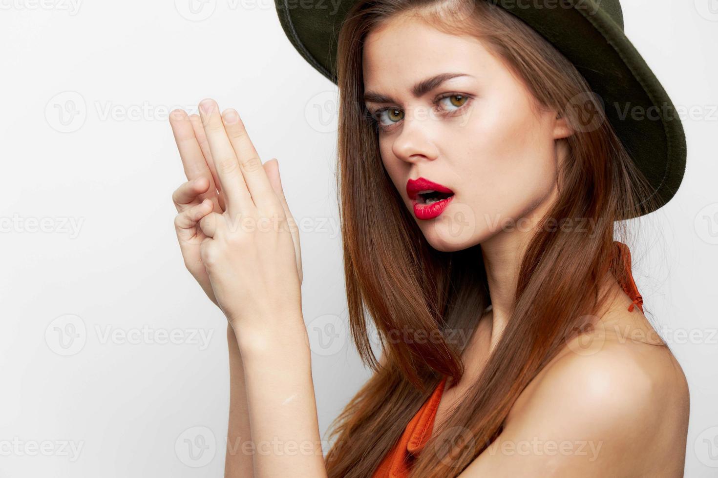 Woman in a green hat With an open mouth, gestures with his hands photo