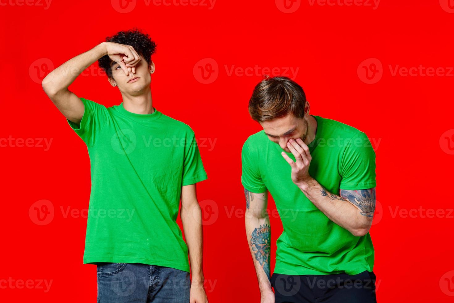 Cheerful friends in green t-shirts gesturing with hands emotions photo