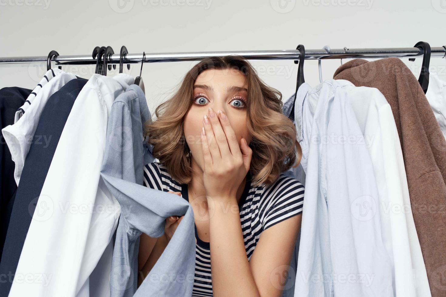beautiful woman trying on clothes shop retail light background photo