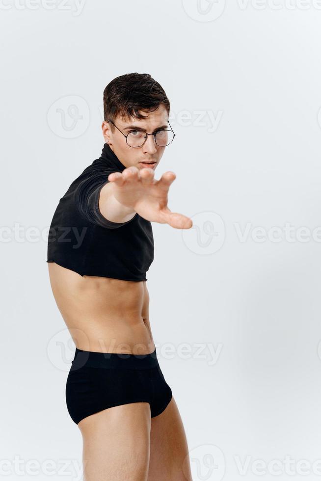 bodybuilder fitness sport man posing on a light background and glasses on the face of the model photo