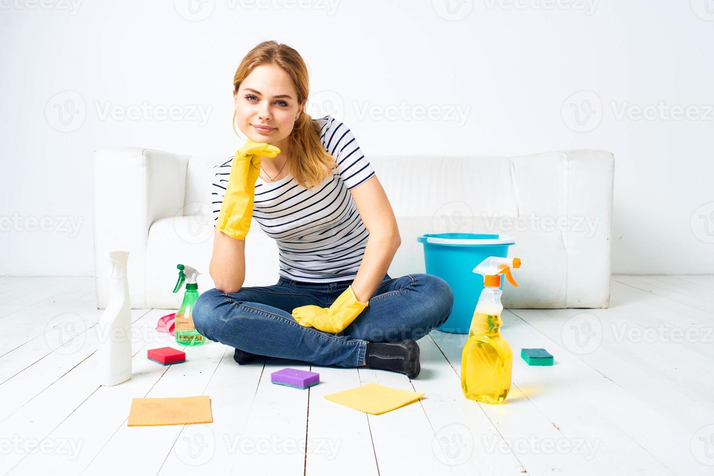 Cleaning lady sitting on the floor cleaning supplies cleaning house interior photo