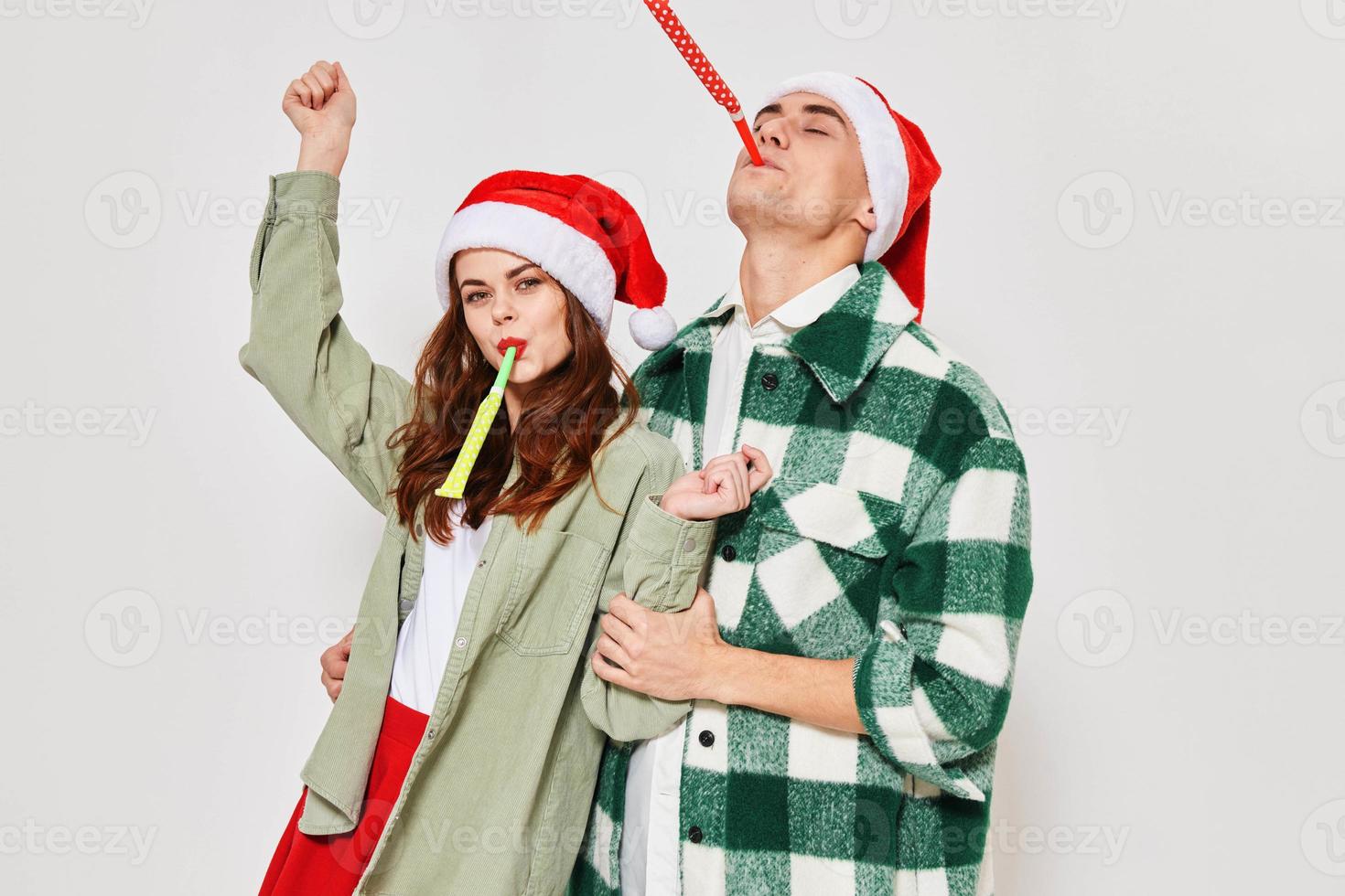 Man and woman in New Year's clothes Santa hat holiday fun emotions Friendship gray background photo