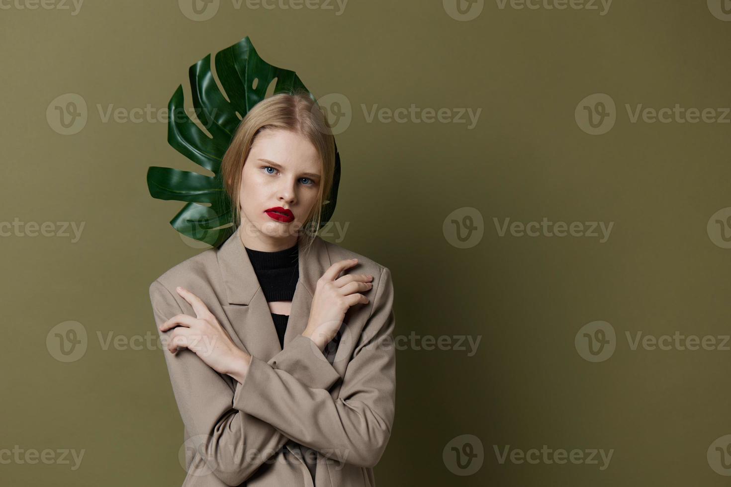 pretty woman green palm leaf coat bright makeup isolated background photo