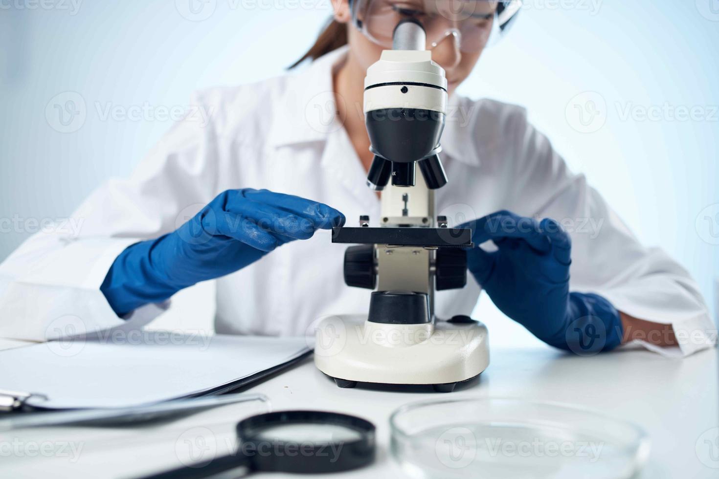 woman scientist laboratory microscope diagnostics chemical solution analyzes photo