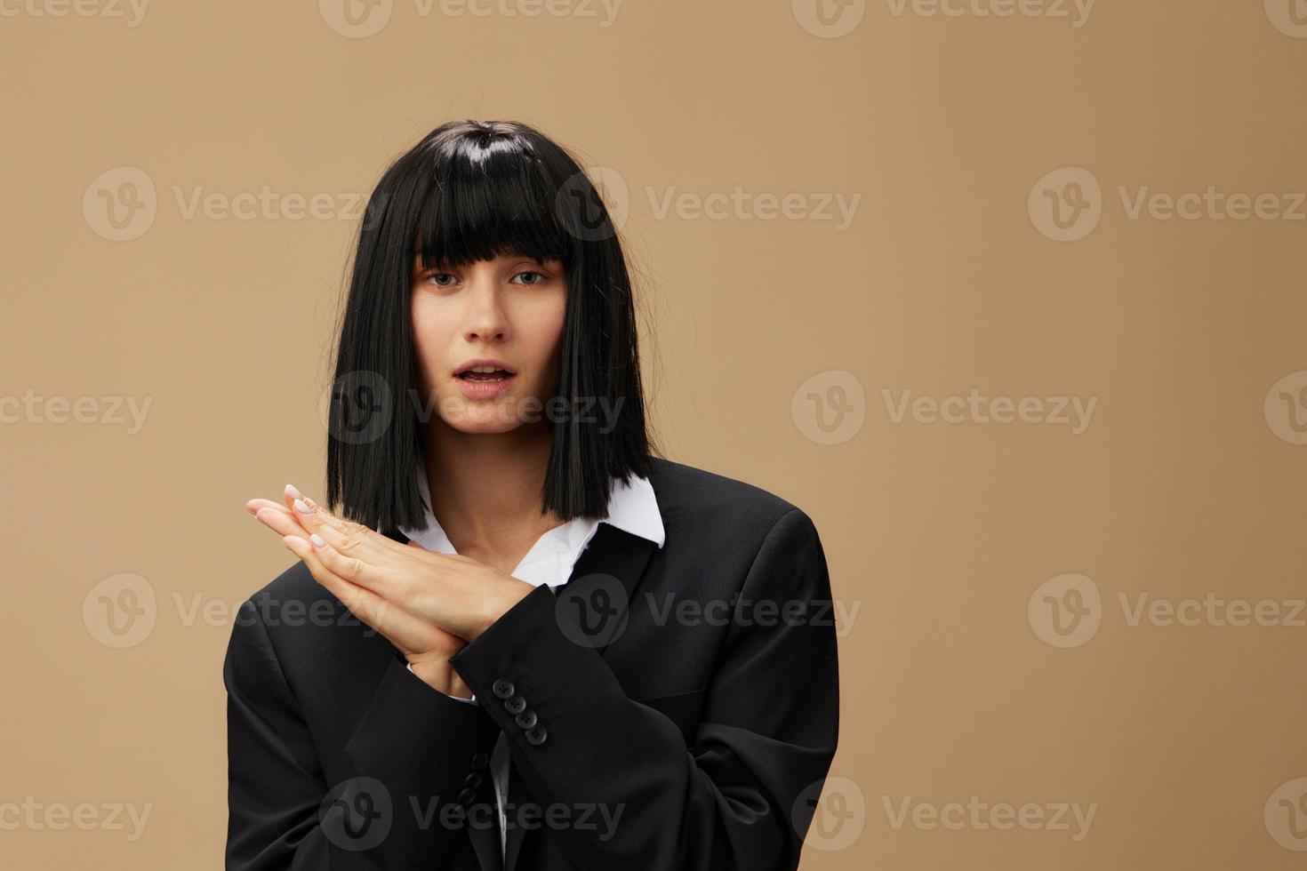 Cute happy adorable brunet lady in classic suit fold hands look at camera posing isolated on pastel beige studio background. Copy space Banner Offer. Pulp Fiction concept. Fashion Cinema photo