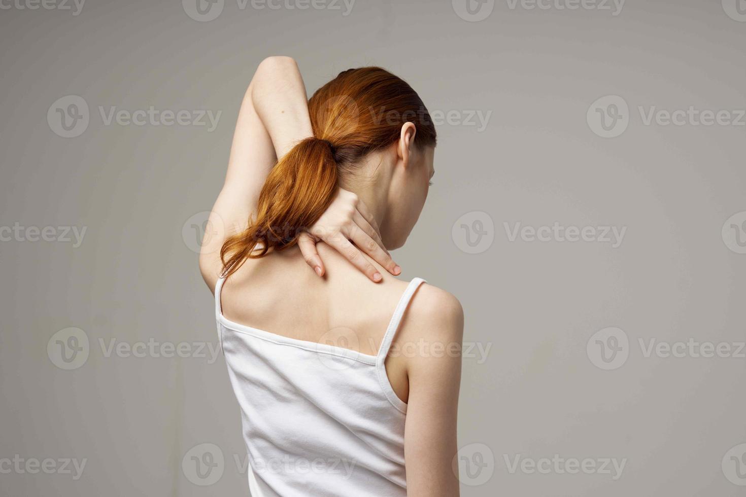 woman doing shoulder exercises health gray background photo