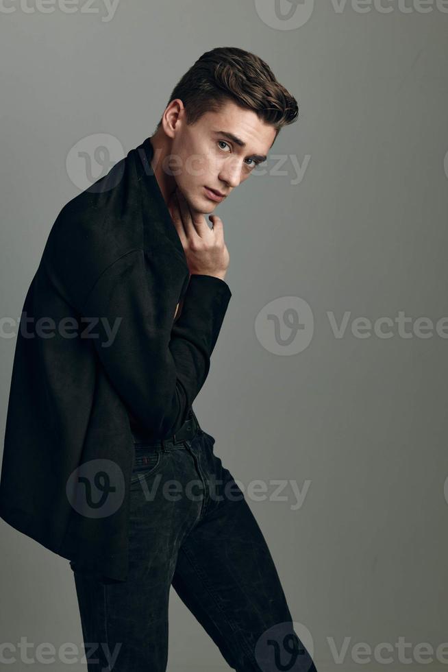 Handsome man black blazer elegant style self confidence cropped look studio fashionable hairstyle photo