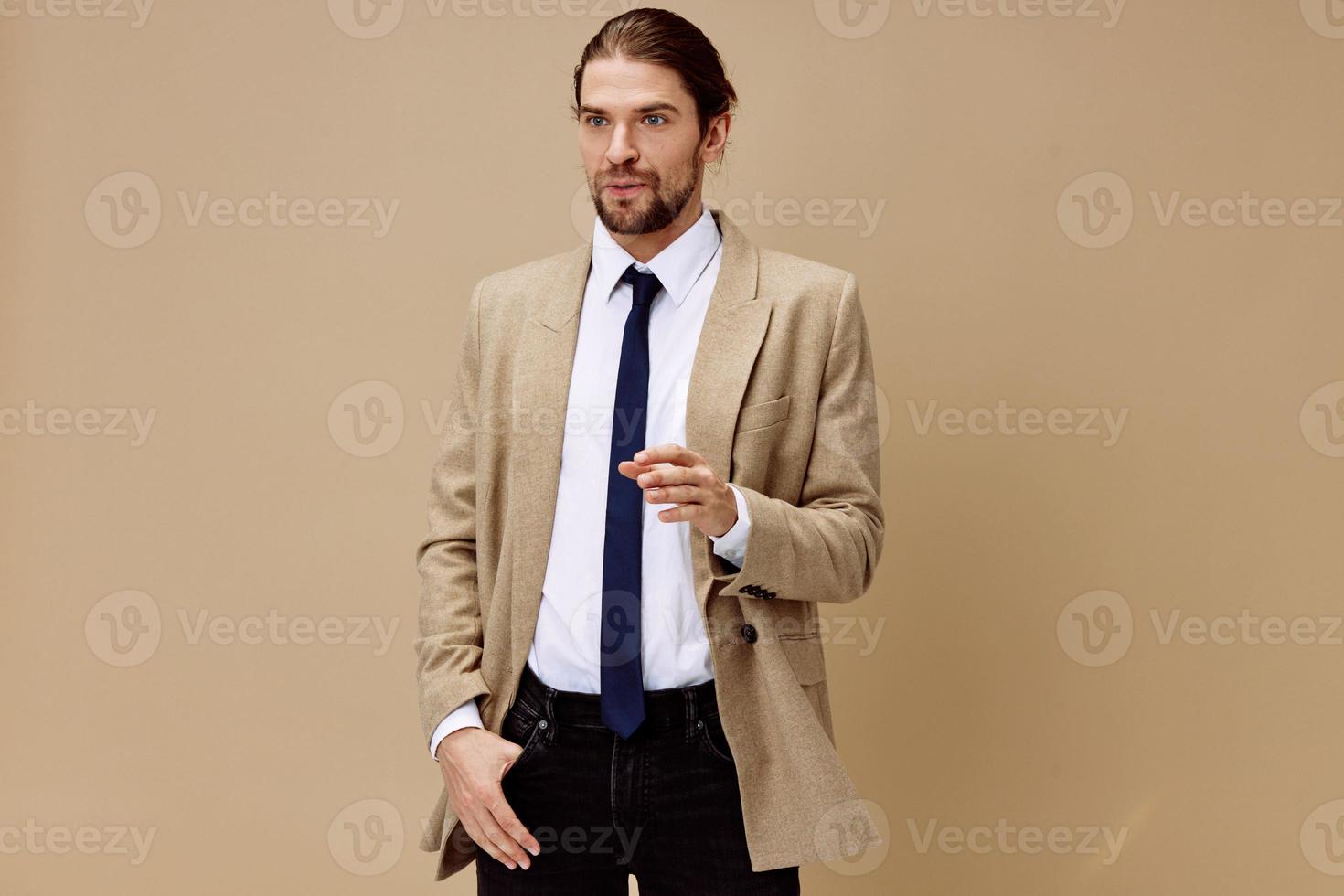 handsome man emotional man in suit gesture with hands beige background photo