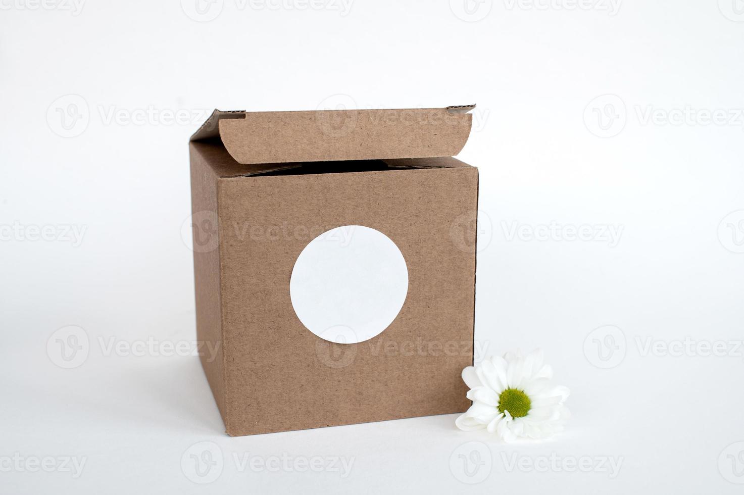 Round sticker mockup on open gift kraft box, tech box and blank sticker, adhesive label photo