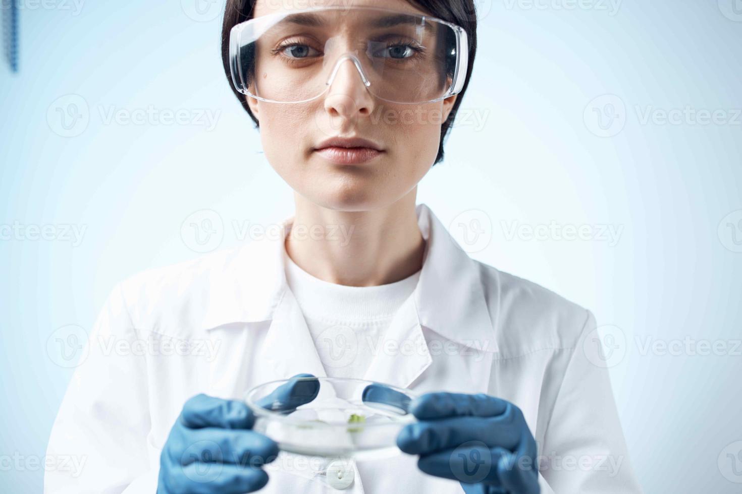 female laboratory assistant in white coat microbiology science work photo