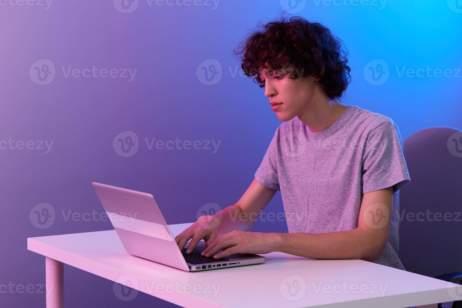 man in front of laptop entertainment violet background photo