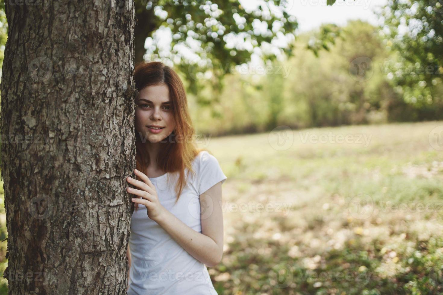 red-haired woman with bouquet of flowers nature trees summer vacation photo