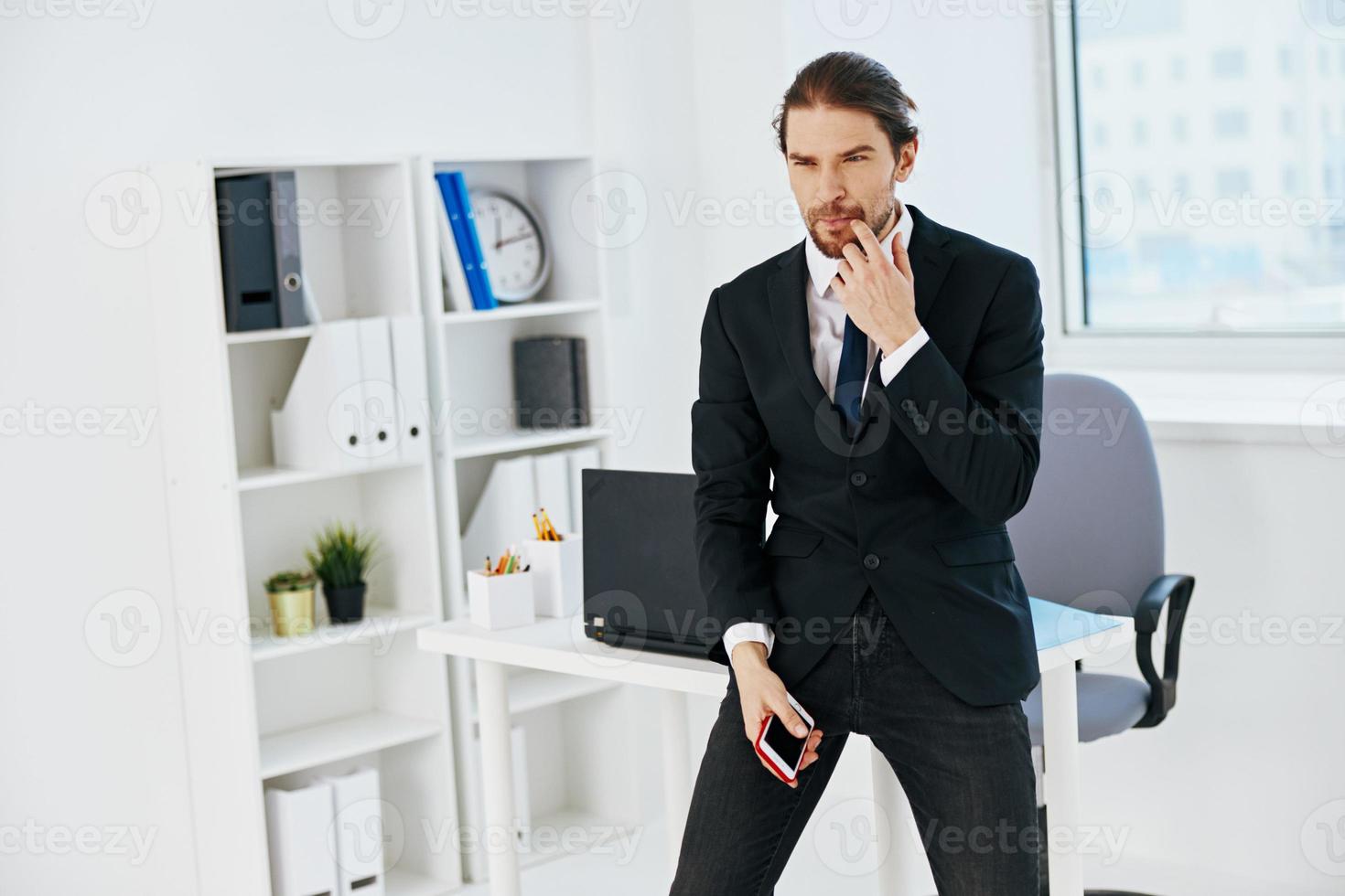 man in a suit in the office with documents lifestyle photo