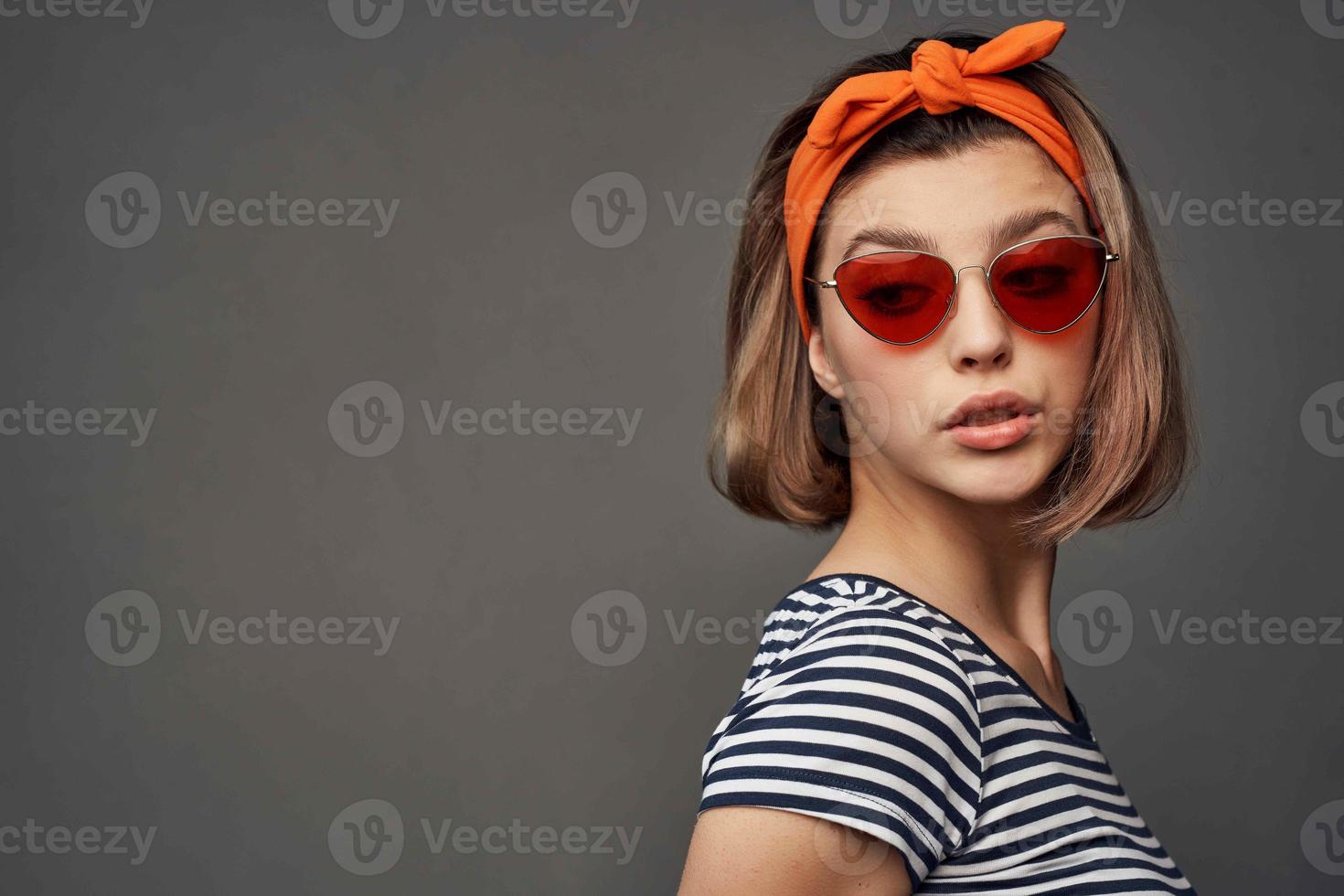 woman wearing sunglasses with orange bandage on head isolated background fashion photo