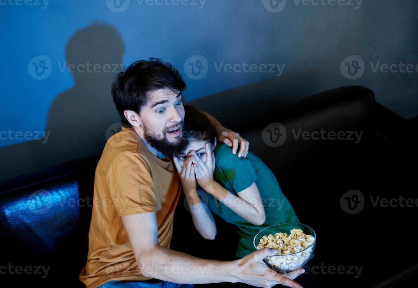 emotional man and woman watching tv indoors photo