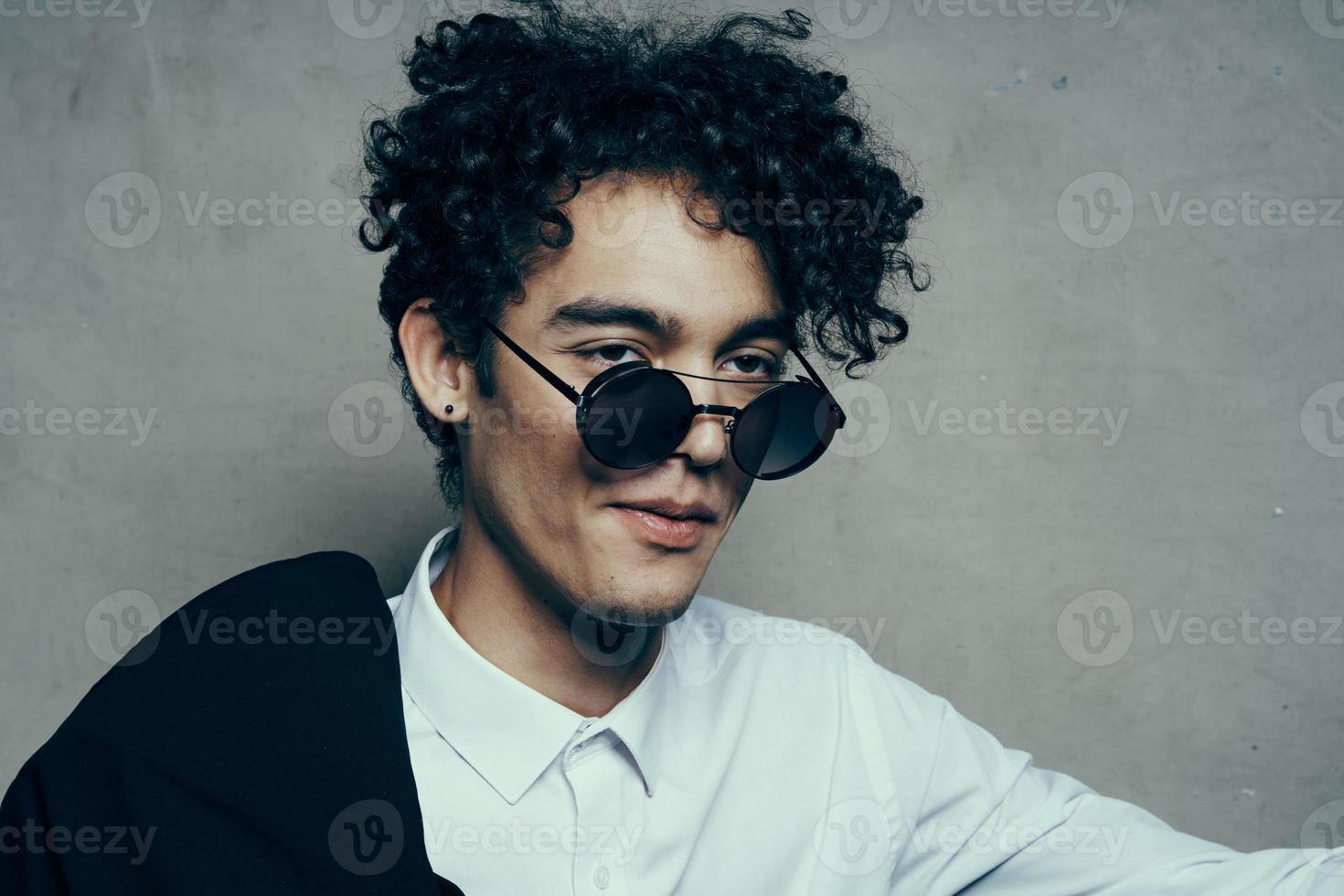 man wearing sunglasses curly hair shirt jacket photo