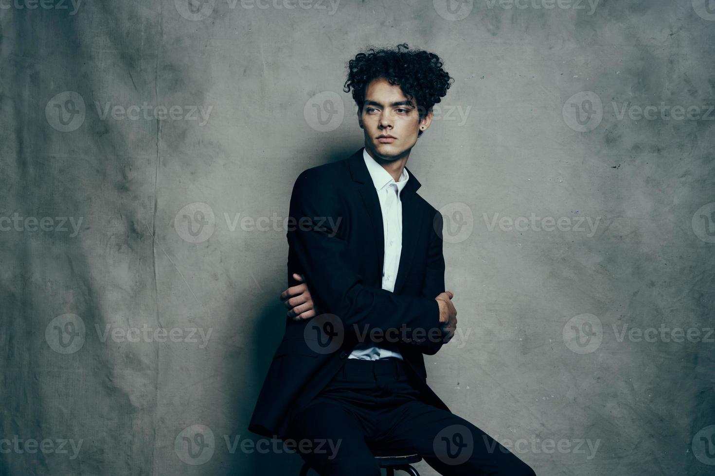 handsome guy curly hair suit self-confidence official photo