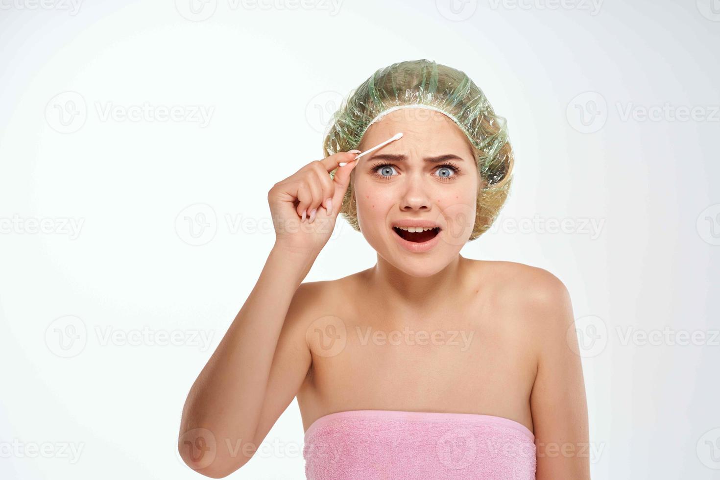 woman with bare shoulders cotton swab facial dermatology photo
