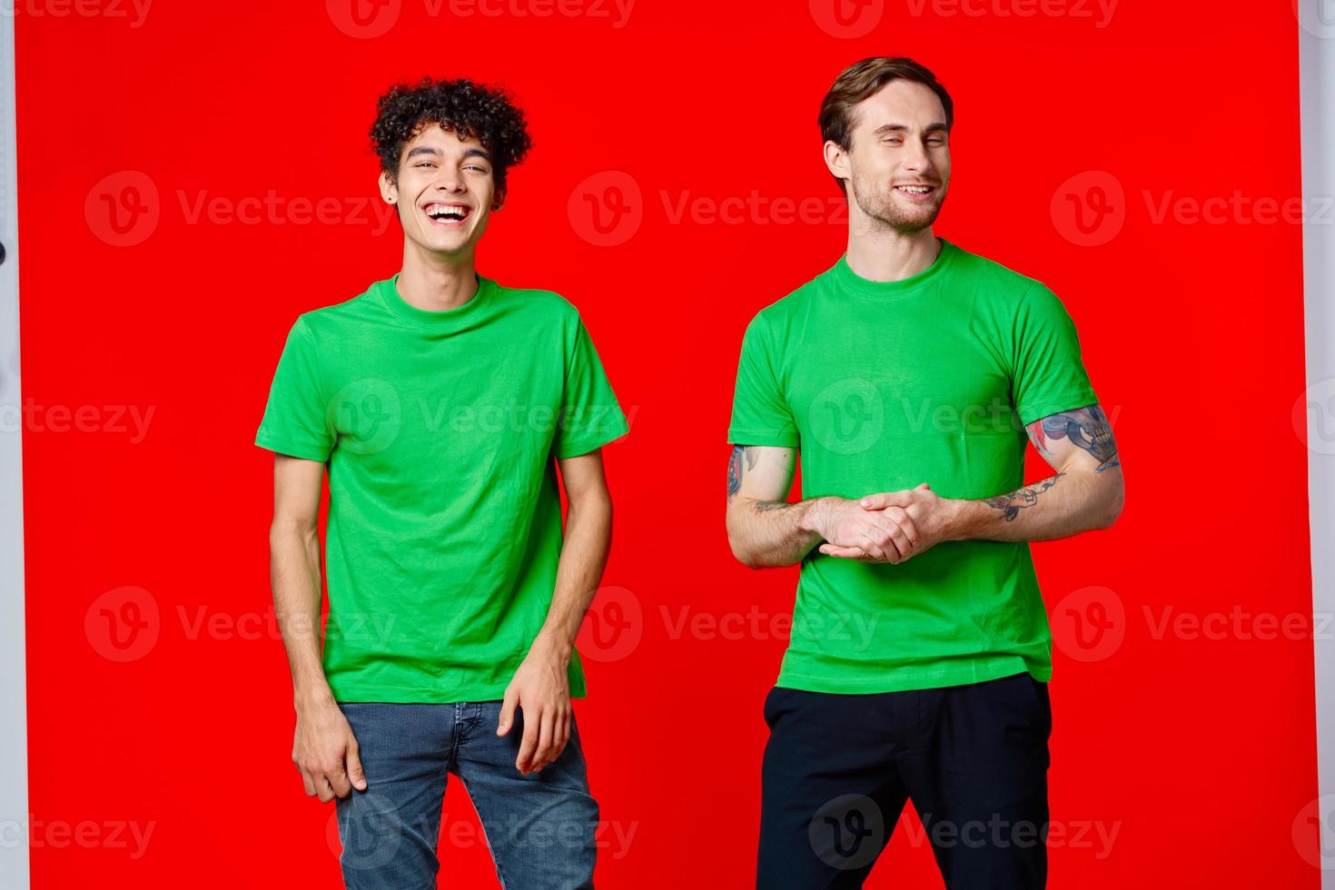 Two cheerful friends in green t-shirts joy of communication photo